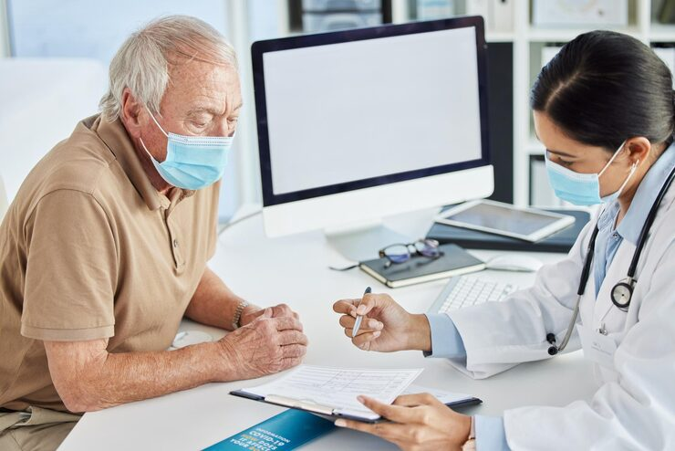 senior man face mask doctor office consultation clipboard talking results male person patient healthcare planning treatment computer mockup physician virus 590464 367890