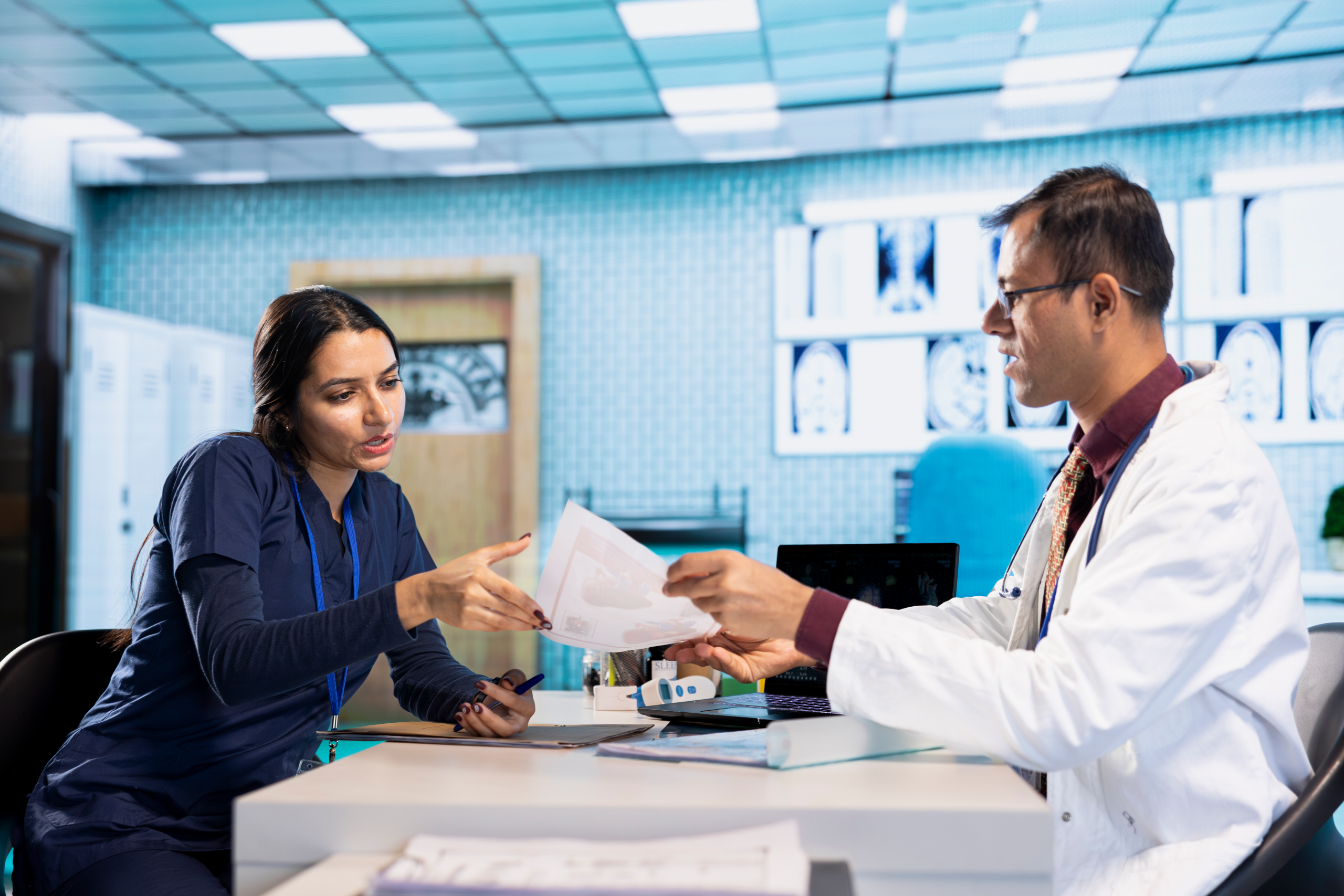 indian expert explaining diagnostics through test results with a male patient