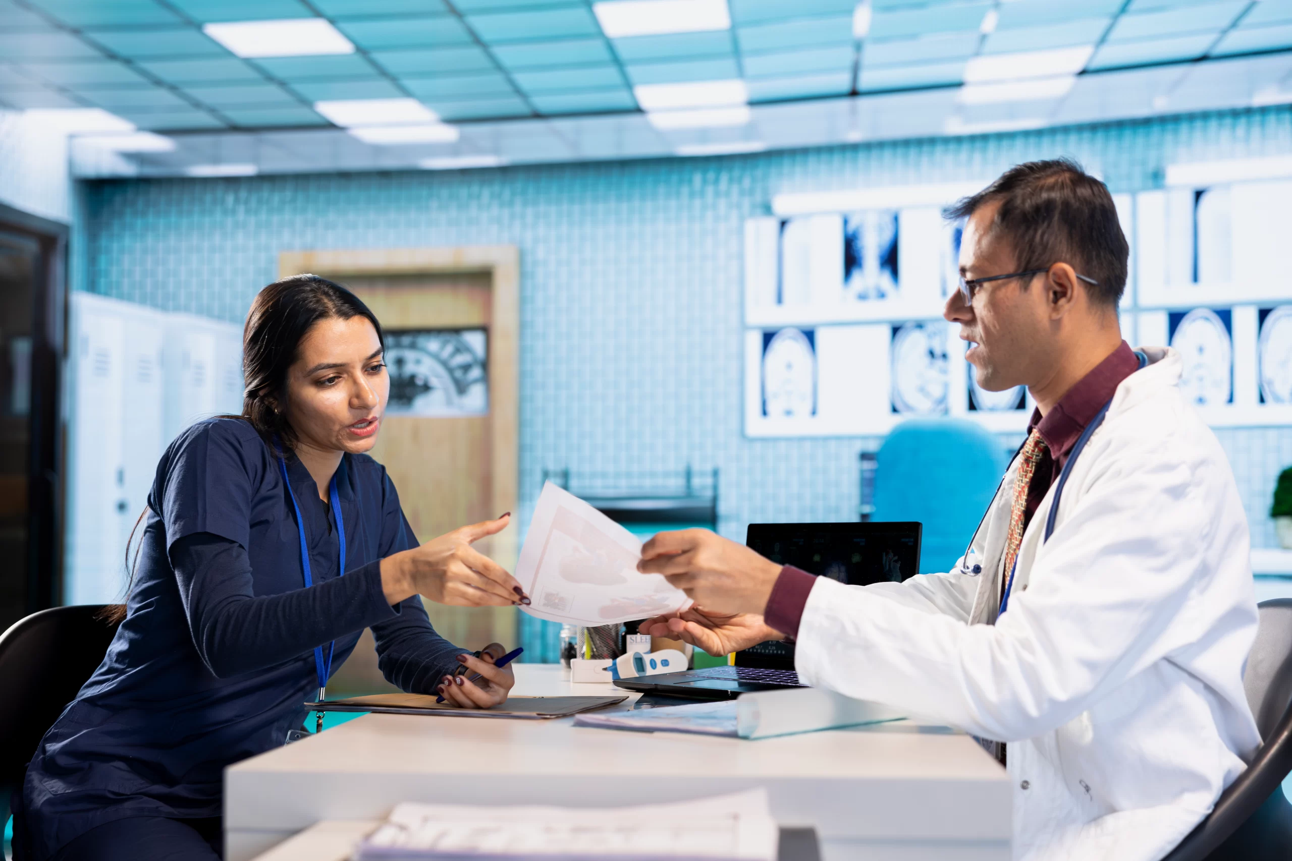 indian expert explaining diagnostics through test results with a male patient