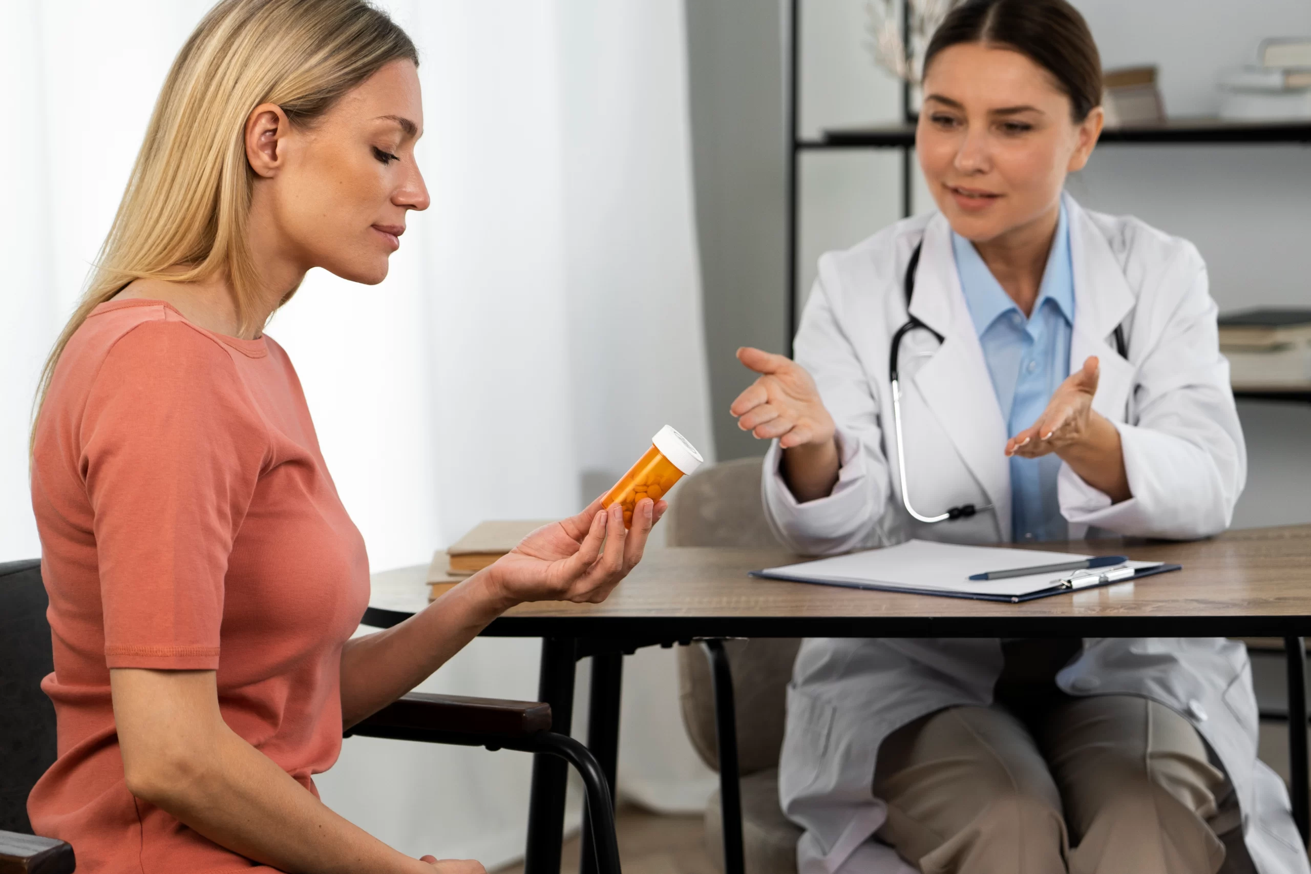 side view woman holding pills container