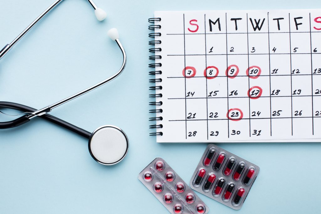 medical treatment calendar with stethoscope pills